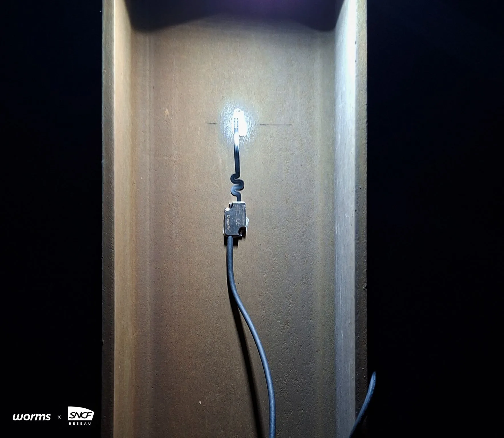 A Dragonfly® sensor bonded to a steel structure, lit by a headlamp