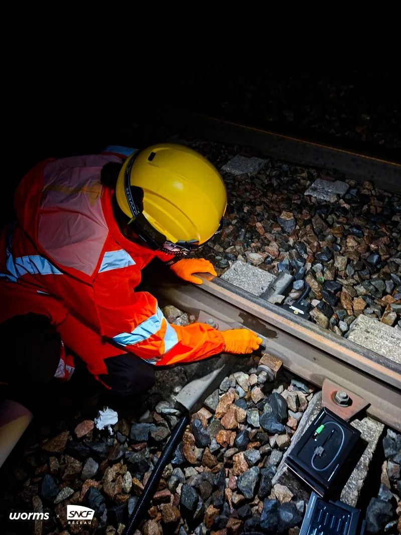 A technician working on the track at night