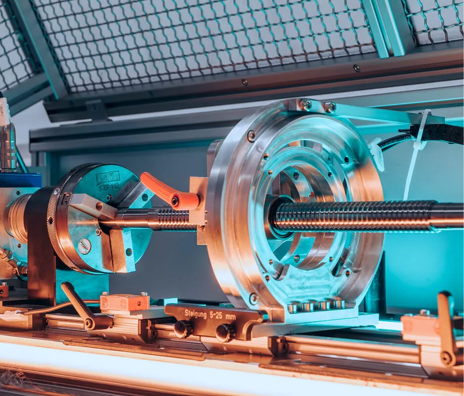 A ball screw on a machine test bench.